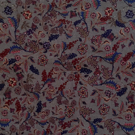 Floral patterned fabric with red, blue, and purple colors on a gray background