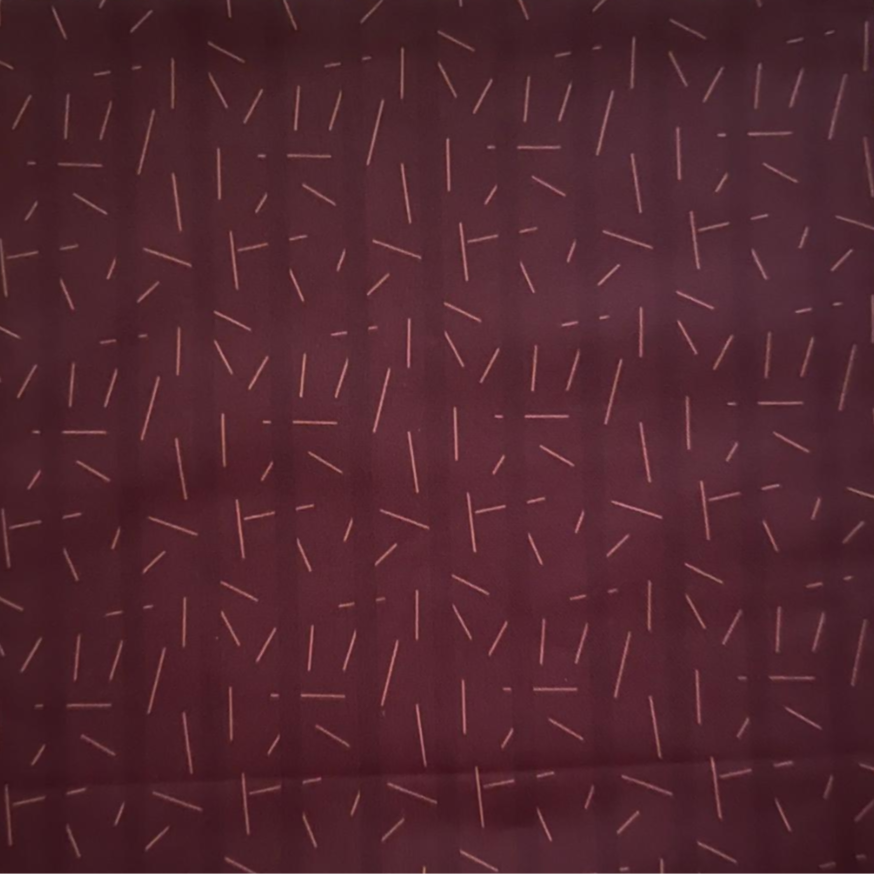 Patterned fabric swatch on a beige background