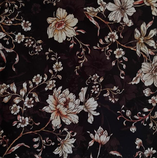 Folded Dark Floral Digital Print Cotton Fabric, showing large cream and gold blossoms on a dark background, ideal for sustainable dresses, men's shirts, and luxurious home decor.