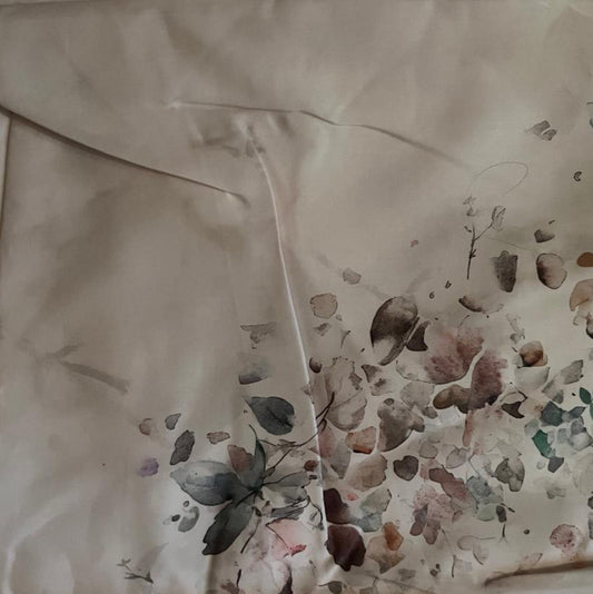 Folded Watercolor Botanical Digital Print Cotton Fabric, showing scattered muted blue and pink elements on a light background, ideal for sustainable dresses, men's shirts, and serene home decor.