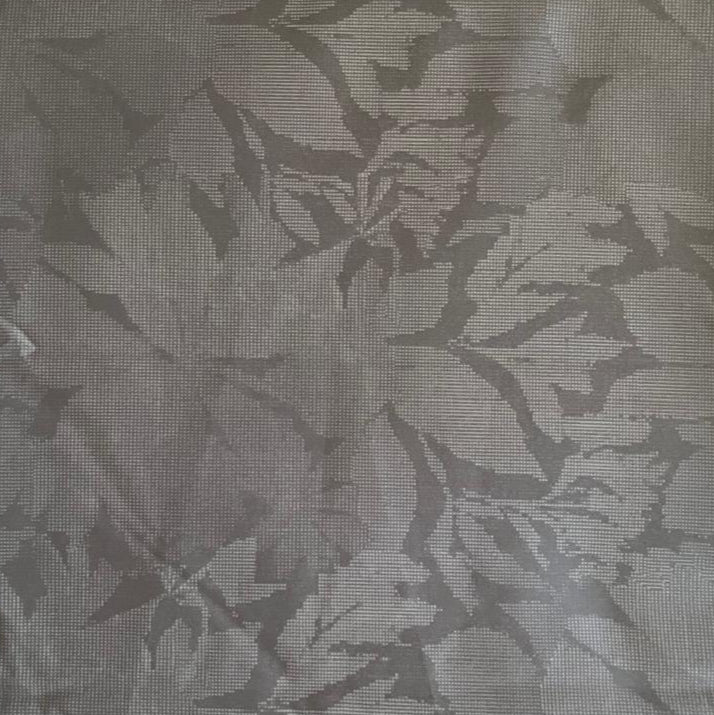 Folded Silver Grey Tone-on-Tone Botanical Digital Print Cotton Fabric, showing subtle leaf patterns, ideal for sustainable dresses, men's shirts, and elegant home decor.