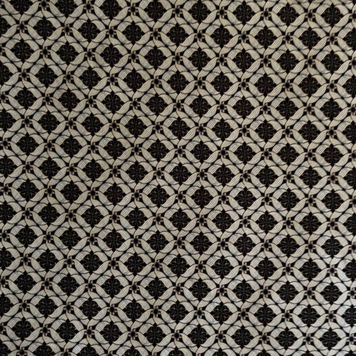 Folded Black and White Classic Geometric Digital Print Cotton Fabric, showing interlocking patterns, ideal for sustainable men's shirts, dresses, and sophisticated home decor.