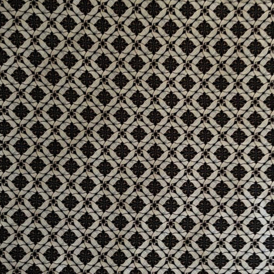 Folded Black and White Classic Geometric Digital Print Cotton Fabric, showing interlocking patterns, ideal for sustainable men's shirts, dresses, and sophisticated home decor.