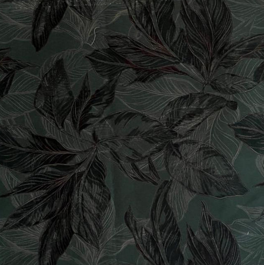 Folded Dark Green Lush Leaf Digital Print Cotton Fabric, showing large botanical patterns, ideal for sustainable dresses, men's shirts, and sophisticated home decor.