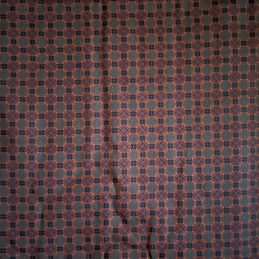 Folded Navy and Rust Micro Geometric Digital Print Cotton Fabric, showing an intricate repeating pattern, ideal for sustainable men's shirts, dresses, and classic home decor.